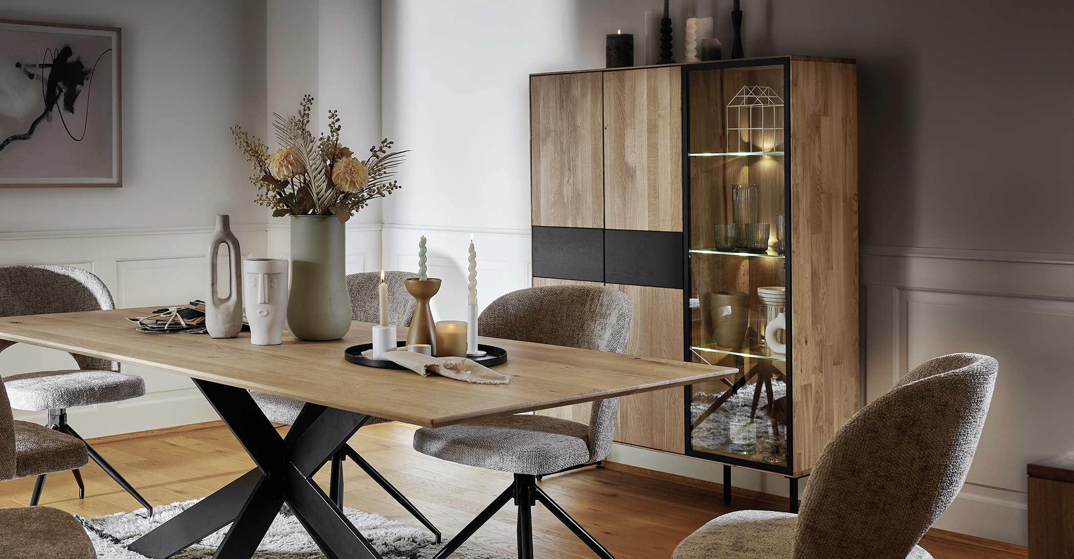 Schrank in Holzoptik mit schwarzen Akzenten und Vitrinenfenster mit integrierter LED-Beleuchtung